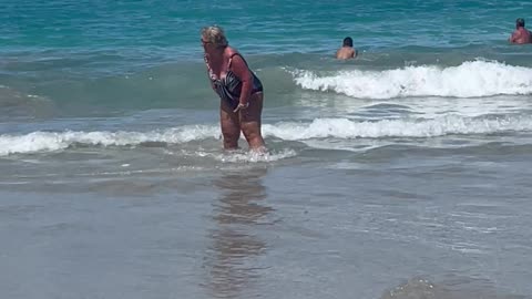 Woman Knocked Over By Wave