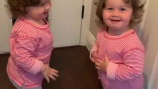 Twin girls get into adorable shoving match