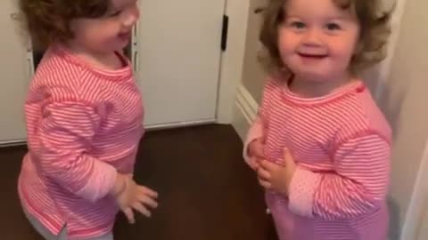 Twin girls get into adorable shoving match