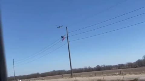 A helicopter carrying a large American