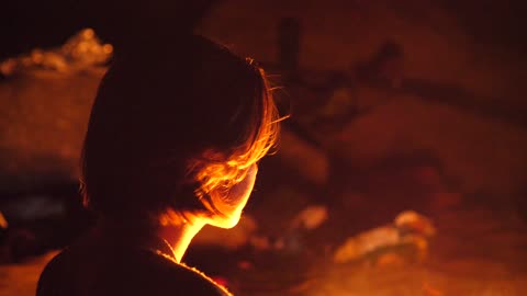 Young Woman Looking Into Fire