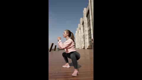 Woman In Pink And Gray Sports Gear Exercising Outdoors