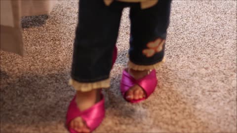 Toddler walks in mommy's heels