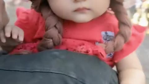 This cute baby looks like a doll