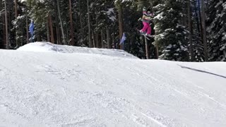 Girl skis of two ramps, falls face first hard into snow, both skis fall off