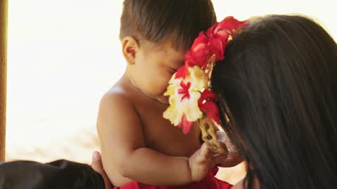 A Boy Removes The Woman Headdress