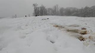 Going sled riding over a jump