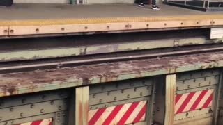 Guy does cable rope arm exercise at train stop