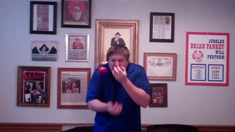 Man Juggles And Eats Three Apples At The Same Time