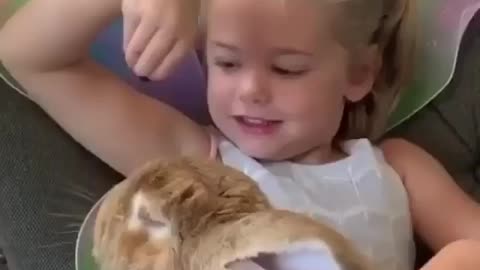 Toddler's are playing with beautiful bunny