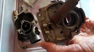 Removing the float valve seat from the carburetor