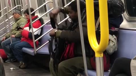 Man puts a lot of backpacks on his back on subway train