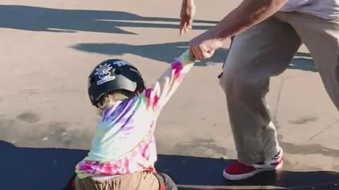 Young Girl Learning To Skateboard With Coach