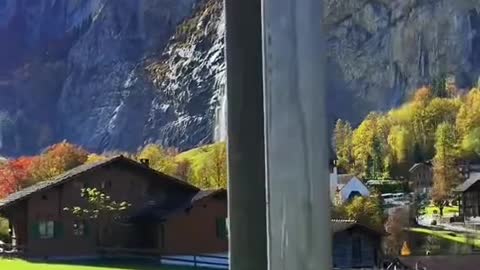 Stunning view of Lauterbrunnen village with awesome waterfall Staubbach and Swiss Alps!