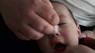 Baby tries to lick the wipe.