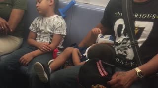 Man and boys fall asleep on train